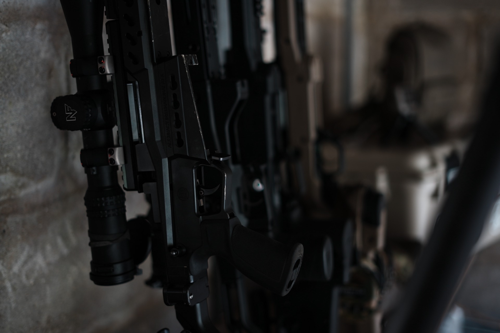 Firearms arm hero. Single strong still: instructor working, kit in use, or environmental wide. Not posed.